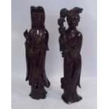 A pair of early 20thC moulded, dark ochre coloured resin figures,