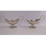 A pair of George III silver twin handled pedestal salt cellars,