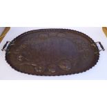 An early 20thC Arts & Crafts oval copper serving tray with spot-hammered,