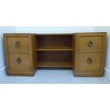 A mid 20thC TH Robsjohn-Gibbings satin mahogany finished inverted breakfront dressing table with