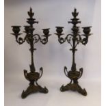 A pair of 19thC parcel gilt and patinated bronze candelabra,