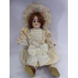 A Max Handwerck porcelain head doll with painted features and weighted, sleeping eyes,