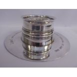 An Edwardian silver inkwell with a cylindrical reservoir and a disc design platform base William