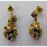 A pair of gold coloured metal pendant earrings, set with rubies,