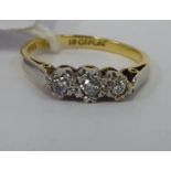 An 18ct gold three stone diamond ring 11