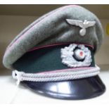 WITHDRAWN A World War II German Luftwaffe peaked cap with a braided eagle and swastika OS6
