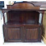 An Edwardian mahogany hanging cabinet with two open shelves and a pair of panelled doors,