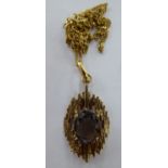 A 9ct gold pendant, set with a smokey quartz,