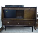A 1960s/70s mahogany sideboard with an arrangement of three drawers/two doors,