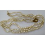 A triple row cultured pearl necklace, on a 9ct gold clasp,