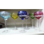 A set of six Bohemian clear and coloured glass pedestal wines with etched fruiting vine and thumb