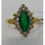 An 18ct gold marquise shaped ring, set with a bevelled emerald,