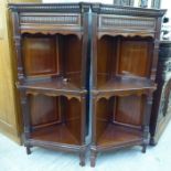 A pair of early 20thC mahogany corner cabinets with two open shelves,