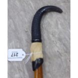 An early 20thC Swiss walking stick with a hoof and claw handle,