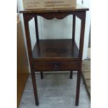 A George III oak nightstand with two open shelves, over a single drawer,