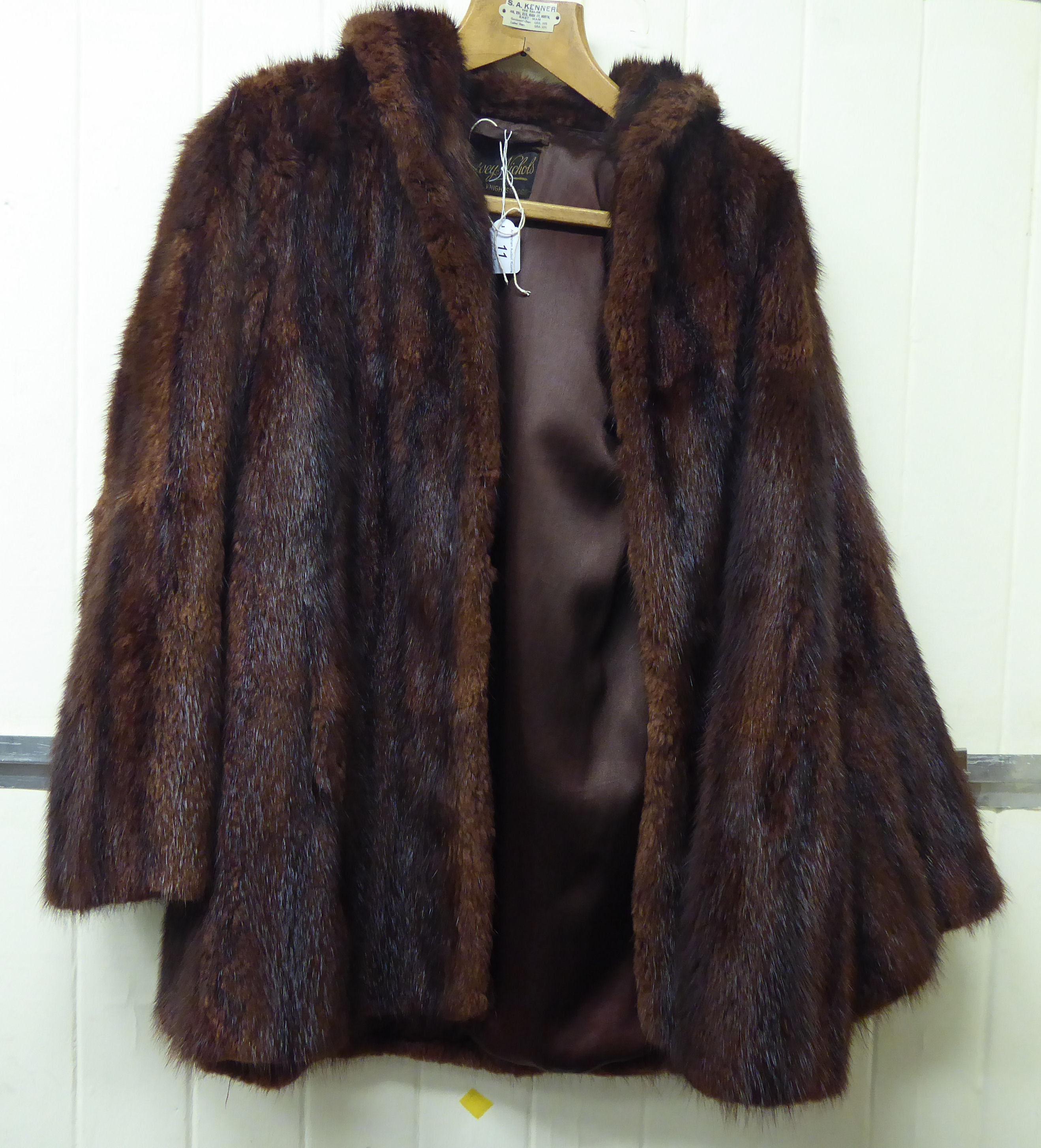 A two-tone brown mink coat with a silk lining bearing a 'Harvey Nichols,