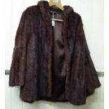 A two-tone brown mink coat with a silk lining bearing a 'Harvey Nichols,