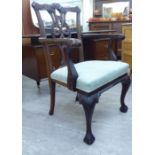 A 1920s reproduction of a Chippendale inspired mahogany framed splat back elbow chair,