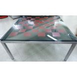 A 1970s Heals chromium plated coffee table with a glass chequerboard top,