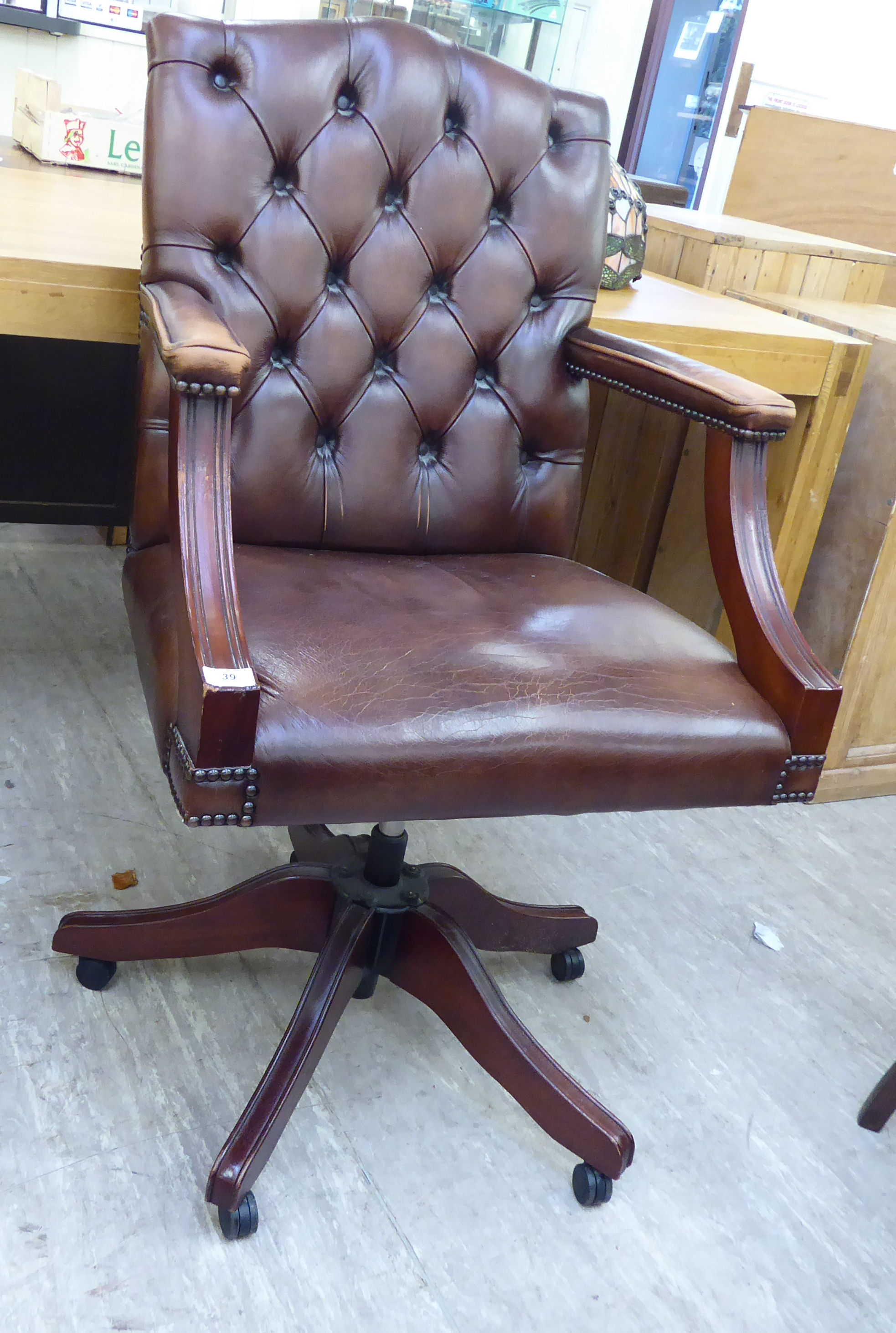 A modern Georgian style part button and stud upholstered brown open arm desk chair,