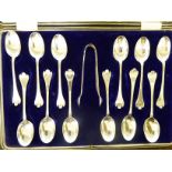 A set of twelve teaspoons and matching sugar tongs,