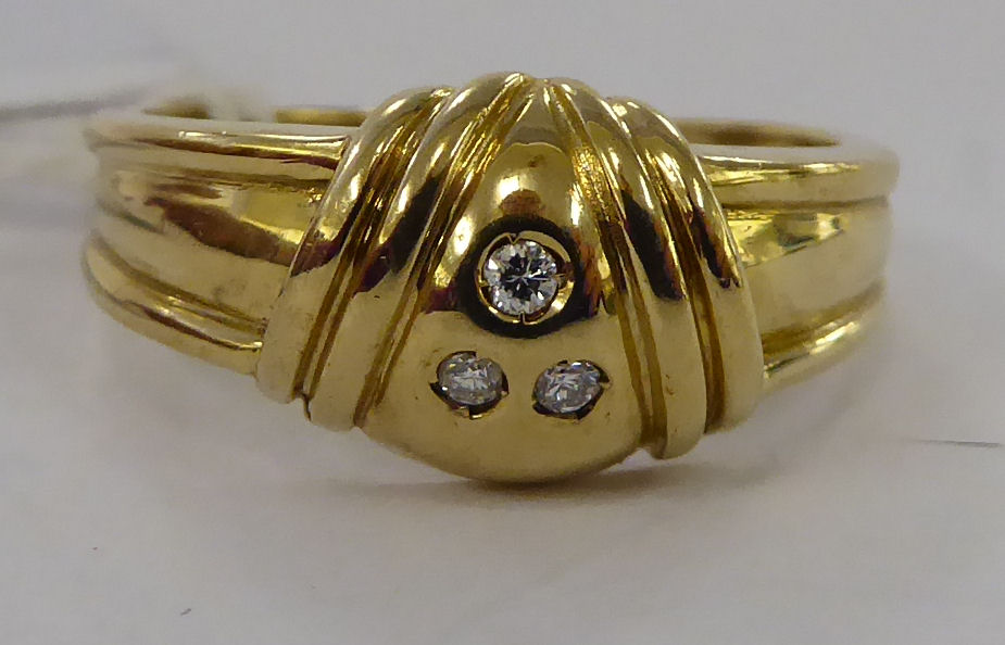 A 9ct gold three stone diamond ring 11