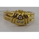 A 9ct gold three stone diamond ring 11