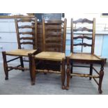 A matched set of three early 20thC ash framed ladderback dining chairs,