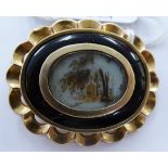 An 'antique' yellow metal and black enamel,