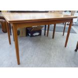 A 1970s teak draw leaf dining table, raised on turned,