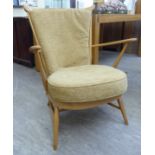An Ercol stained beech easy chair with a spindled back and swept, open arms,
