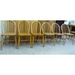 A set of six Ercol stained beech framed, spindle back dining chairs, raised on turned,