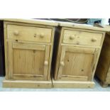 A pair of modern pine bedside cabinets, each with a single drawer and panelled door,