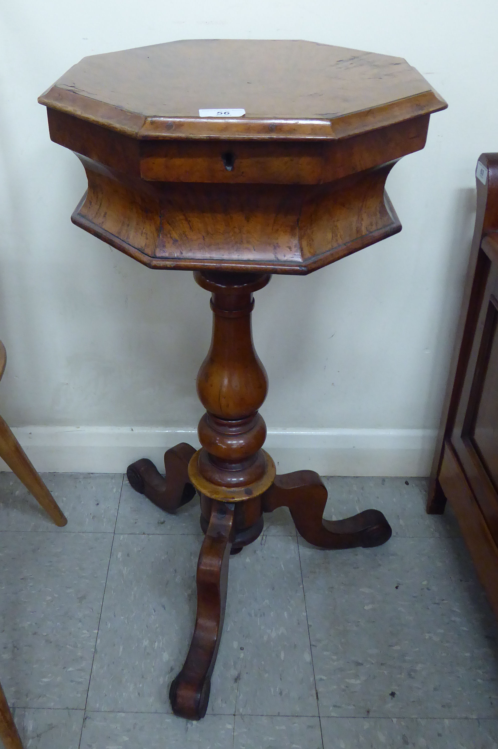 A late Victorian walnut pedestal sewing table of octagonal form,