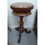 A late Victorian walnut pedestal sewing table of octagonal form,