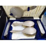 A five piece silver backed dressing table set with engine turned decoration Birmingham 1930 cased