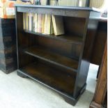 A modern stained and carved oak open front three-tier bookcase,