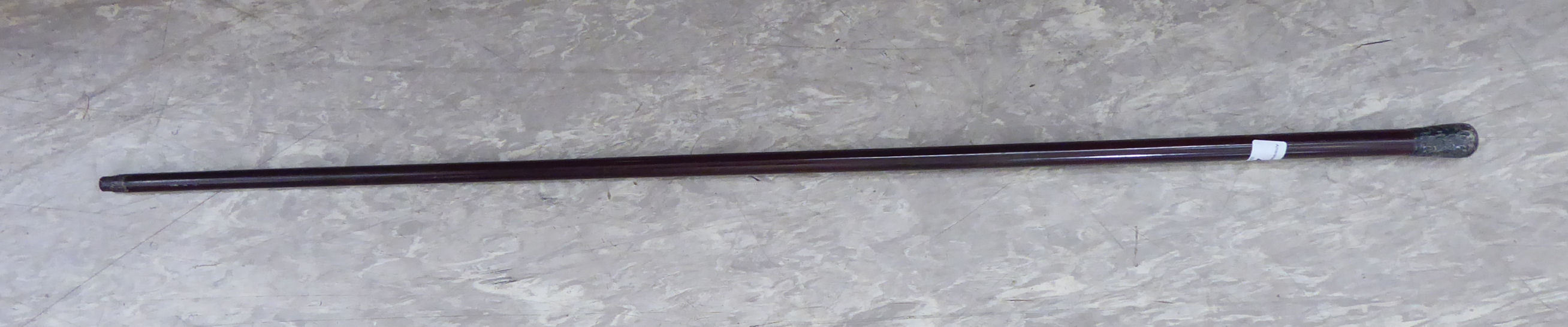 A late 19th/early 20thC walking cane with a tapered, lacquered shaft and a foliate scrolled,