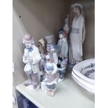 Five Lladro porcelain figures: to include a young boy, girl and dog beside a snowman 7.