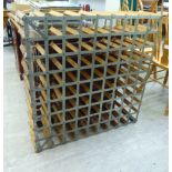 A mid 20thC pine and steel mounted wine rack with provision for eighty-one bottles 36''sq F