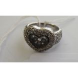 An 18ct white gold pave set floating diamond heart shaped ring 11