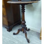 A late Victorian walnut and mahogany pedestal table, raised on a tapered,