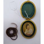 A late 19thC half-length portrait miniature, a woman holding a pair of binoculars, in a glazed,