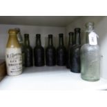 Eight similar 'antique' green glass bottles, each inscribed 'Tower Brewery,