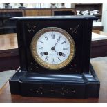 A late Victorian gilded black slate cased mantel clock with a platform top and straight sides;