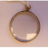 An 'antique' 9ct gold framed, circular, open portrait locket,