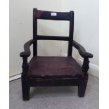 A late 19thC child's country made stained pine framed, bar back elbow chair,