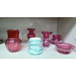 Five pieces of decorative glassware: to include a cranberry glass cream jug with a draw loop handle