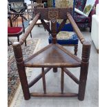 A late 19thC oak framed wood turner's chair with a carved splat, ring turned arms and a solid seat,
