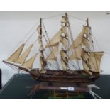 A stained wooden model of a triple masted frigate under sail 29''L overall CA
